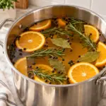 Orange rosemary brine for turkey ready to chill in a stainless steel pot