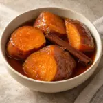 Camotes en dulce served in a round bowl with cinnamon and piloncillo syrup.