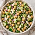 Square overhead view of chickpea cucumber salad with feta and fresh parsley