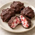 Square view of chocolate strawberry yogurt clusters with a thin shell and strawberry-studded yogurt center.