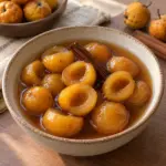 Square image of seeded tejocote halves in cinnamon piloncillo syrup