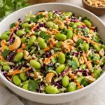 Square view of edamame crunch salad with colorful vegetables and cashew pieces
