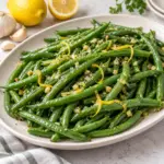 Square platter of green beans with garlic and lemon