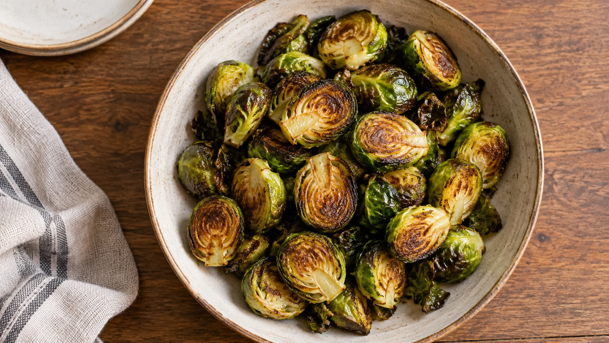 Overhead view of halved roasted Brussels sprouts on a serving platter
