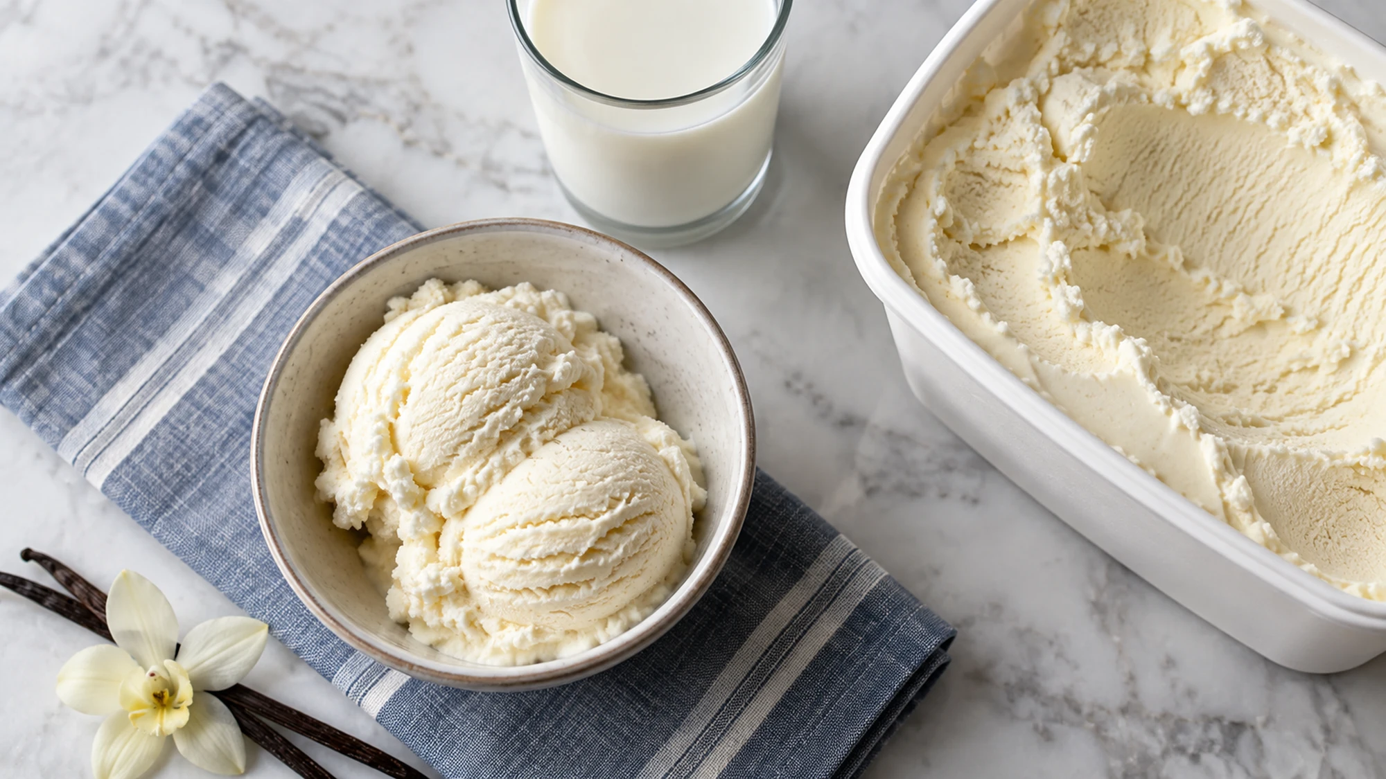 Vanilla ice cream in a bowl beside an open plain tub and a glass of milk.