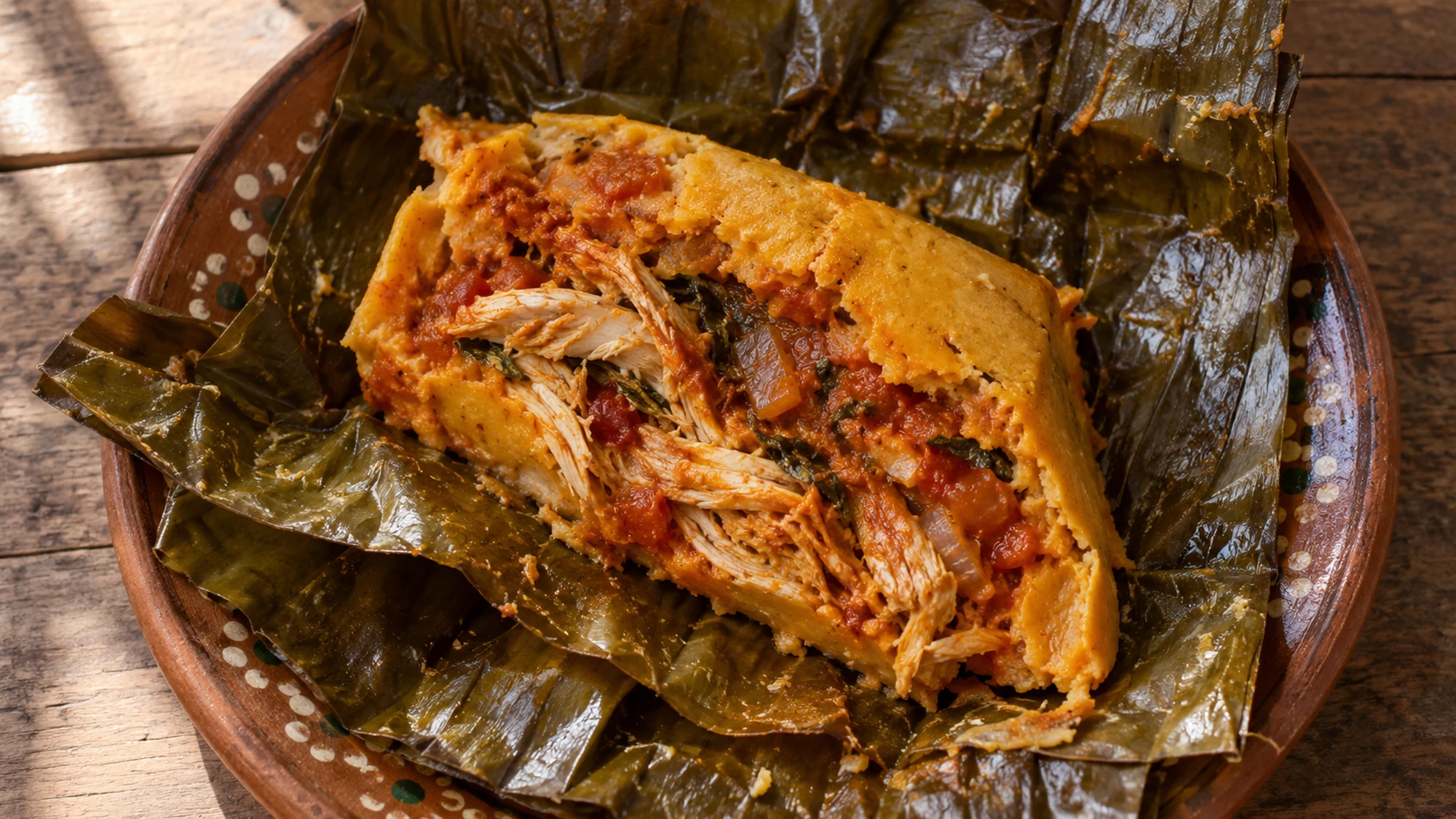 Achiote masa pressed over banana leaves