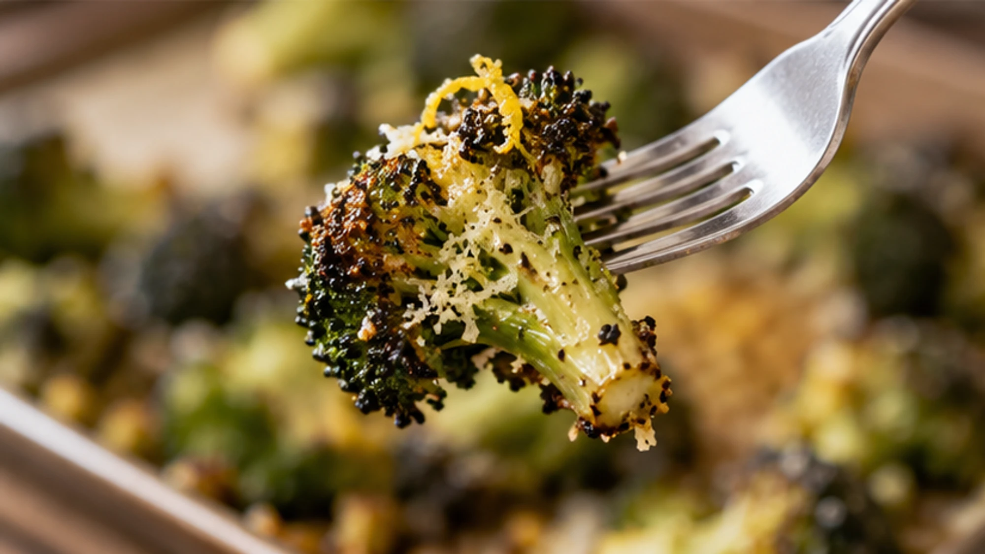 Frozen broccoli florets roasting on a hot pan with browned edges.