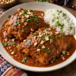 Chicken in roasted peanut sauce with chopped peanuts and cilantro