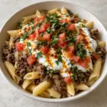 A square view of Turkish pasta with penne, beef, garlic yogurt and a paprika butter finish.